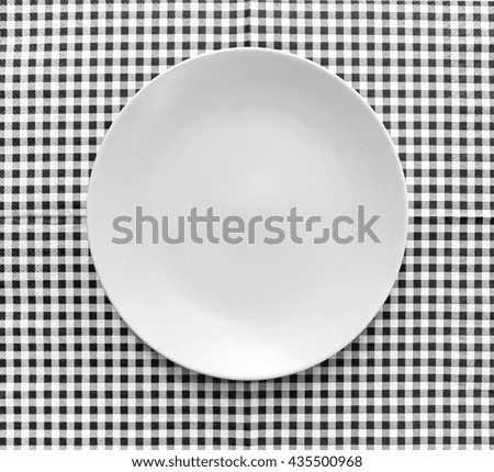 the plate on checkered tablecloth