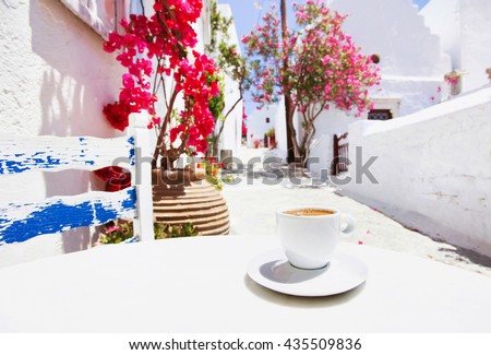 Traditional greek coffee in a cafe with beautiful mediterranean street on the background