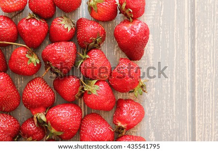 Strawberries on wooden grey desk. Stock photo.