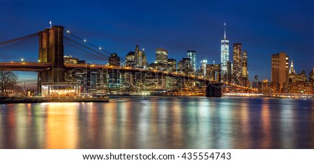 New York - Panoramic view of Manhattan Skyline with skyscrapers  and famous Brooklyn Bridge by night, big size 