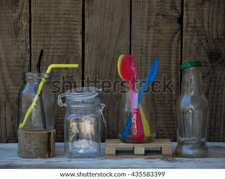 Different empty jar and bottles on wooden background