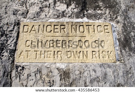 danger notice carved into rock