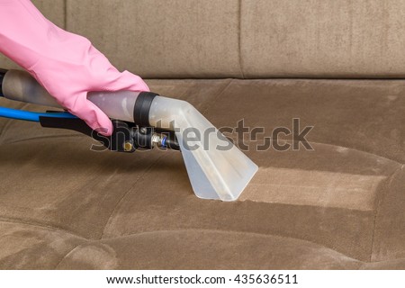 Sofa chemical cleaning with professionally extraction method. Upholstered furniture. Early spring cleaning or regular clean up. Royalty-Free Stock Photo #435636511