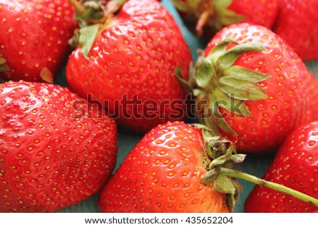 Strawberries on wooden blue desk. Stock photo.