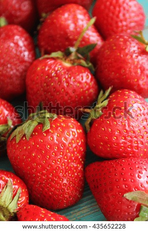 Strawberries on wooden blue desk. Stock photo.