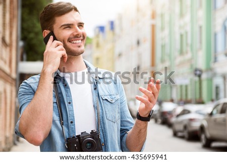 Cheerful man talking on cell phone.