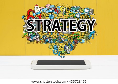 Strategy concept with smartphone on yellow wooden background