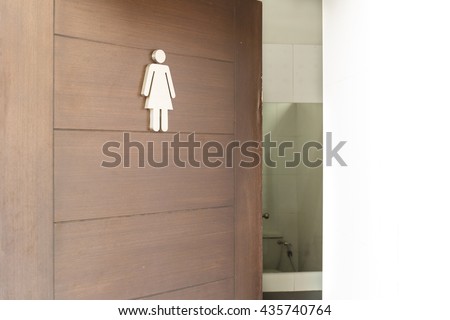 Female toilet sign on wooden door.