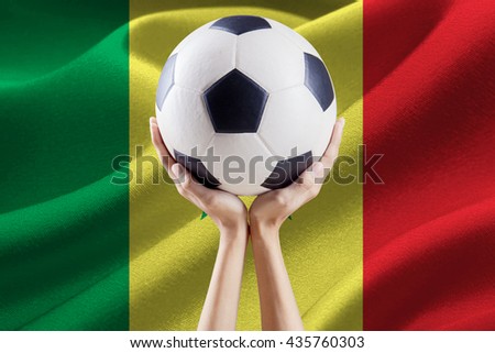 Soccer ball on the top of hands with national flag background of Senegal