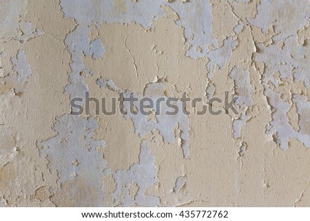 Yellow chapped plaster wall as background texture