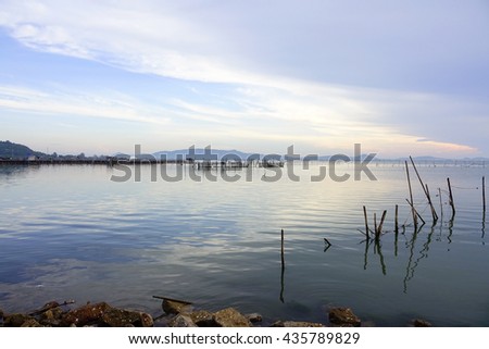 Lake view befor sunrise with bamboo fence on foreground,select focus with shallow depth of field:ideal use for background.
