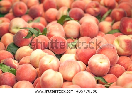 Peaches close up. Early morning in farmers market. Colorful fruit background  Royalty-Free Stock Photo #435790588