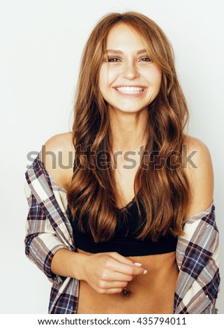 young pretty brunette girl hipster on white background casual close up dreaming isolated smiling