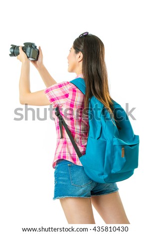 Happy asian woman tourist taking photos on white background