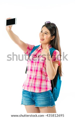 Happy asian woman tourist taking selfie and thumb up on white background