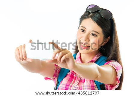 Happy asian woman tourist taking selfie on white background