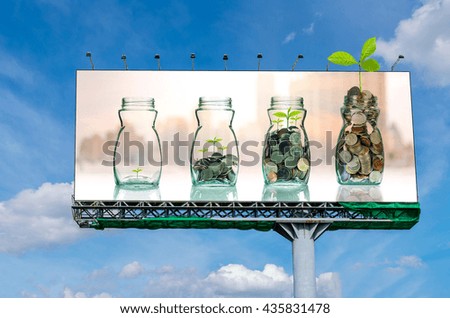 Billboard on beautiful sky showing the mix coins and seed in clear bottle on on cityscape photo blurred cityscape background for advertisement, Business investment growth concept 