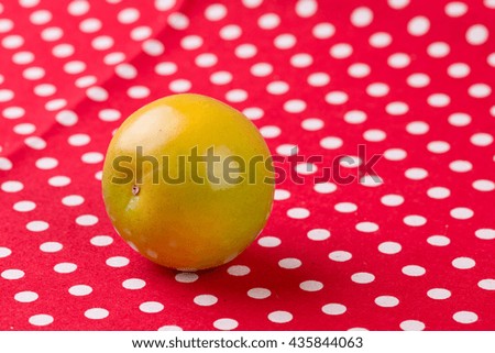 Orange on red polka dots background