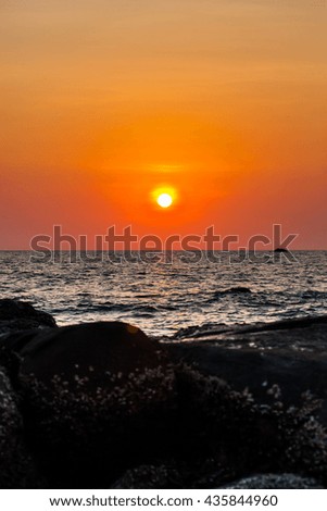 Beautiful blazing sunset landscape on the beach. at the sea and orange sky,Thailand.
