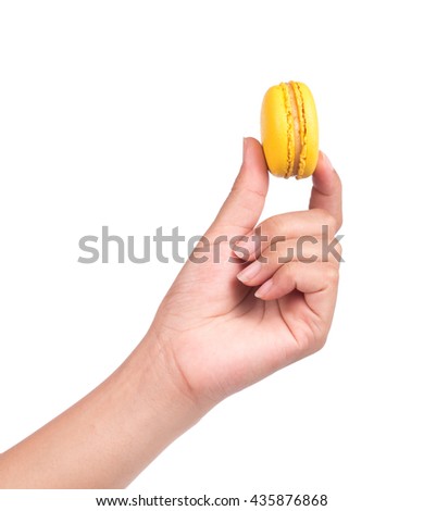 hand holding Sweet and colourful french macaroons or macaron isolated on white background