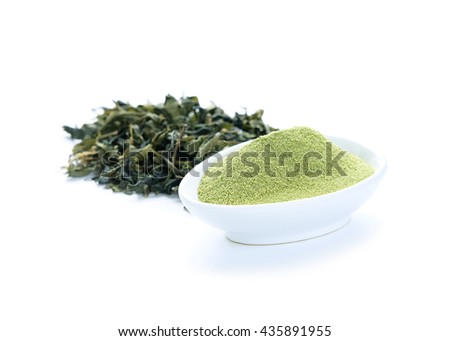Matcha Green Tea powder with Dried green tea leaves isolated on white background.