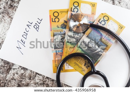 Stethoscope with wording of "Medical Bill" showing expensive healthcare or expensive medical bill with Australia Aussie Bank Notes