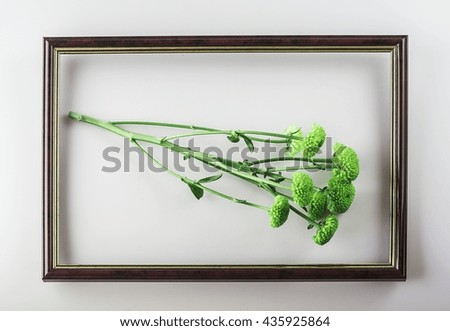 Picture of green flowers in wooden brown frame