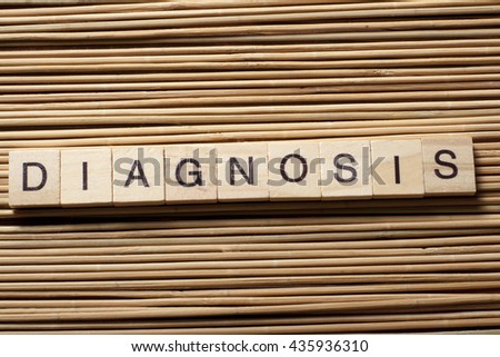 Diagnosis written in wooden cubes on a table.