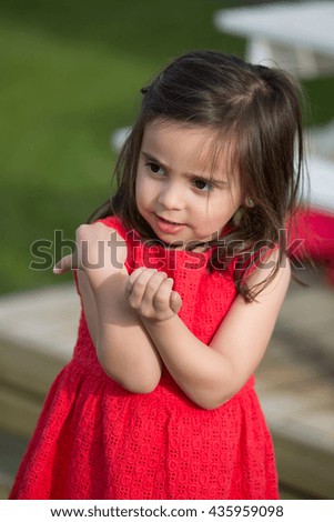 Little girl playing alone in garden