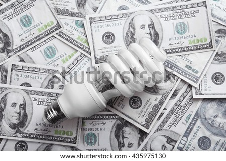 Electric bulb on dollars background