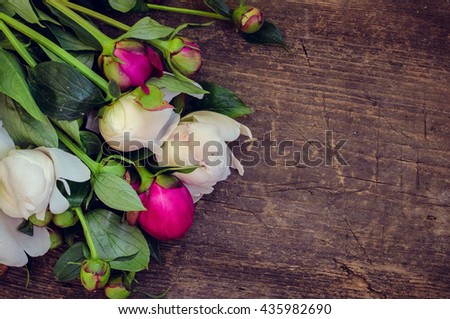 Peony background. Fuchsia, pink and white peonies on wooden table with place for text. Spring flowers peonies. Happy Mothers Day. Mother's Day greetings card. Mothers Day gift. Copy space.
