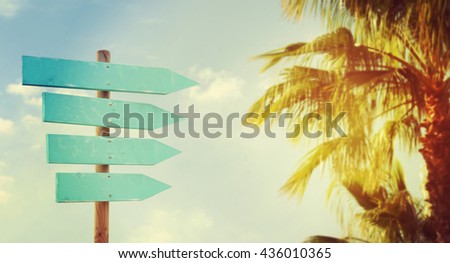 Empty wooden direction sign at the tranquil beach