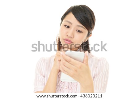 The female office worker uses the smart phone 