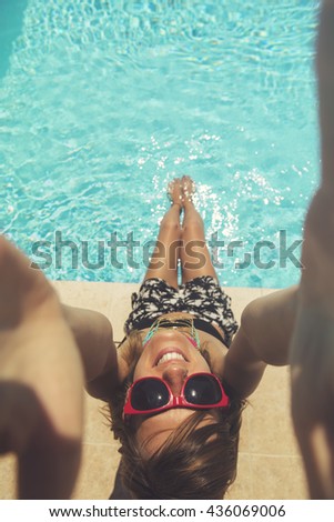 Beautiful woman having fun on the pool.