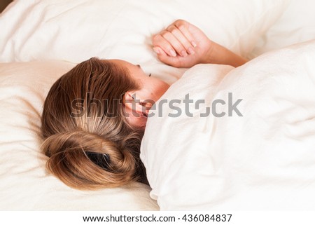 Beautiful young woman sleeping in bed. Toned photo.