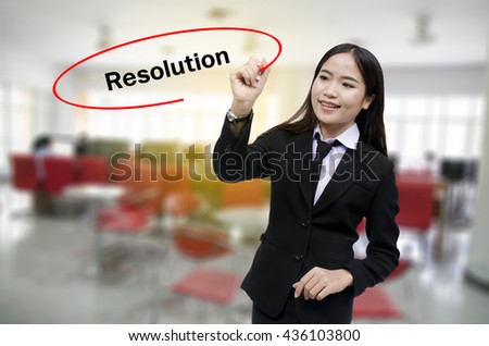Businesswoman Hand writing Resolution with black marker on visual screen. Isolated on gray background. Business, technology, internet concept. Stock Photo