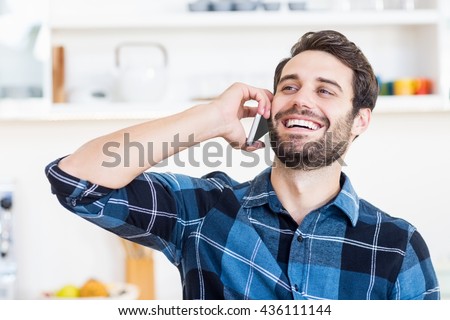 A man is talking on the phone and smiling at work Royalty-Free Stock Photo #436111144