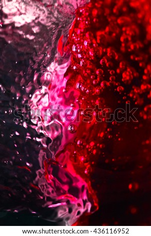 Red wine on black background, abstract splashing.