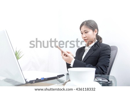 Young beautiful business woman working with notebook computer in the office