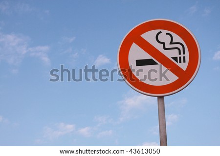 No smoking road sign on blue sky.