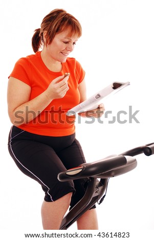 Woman taking a break while on exercise bike over white