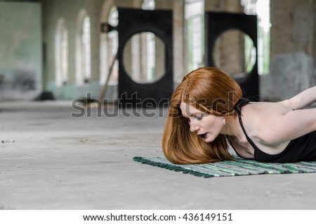 redhead girl with black make-up exercise yoga positions