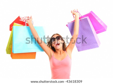 Shopping woman very excited. Shopping. Dynamic picture of young woman on a shopping spree with lots of bags.