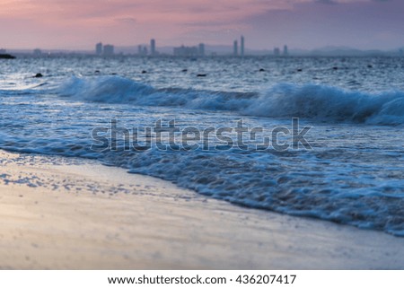 Morning sea wave with city background