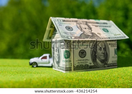 Cottage made of dollar banknotes, housing and car loan. 