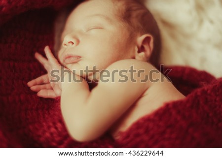 cute gorgeous little boy sleeping in big red kerchief