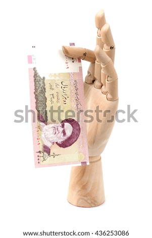 2000 Iranian rials bank note. Rial is the national currency of Iran. the national money in hand wood on the white background.