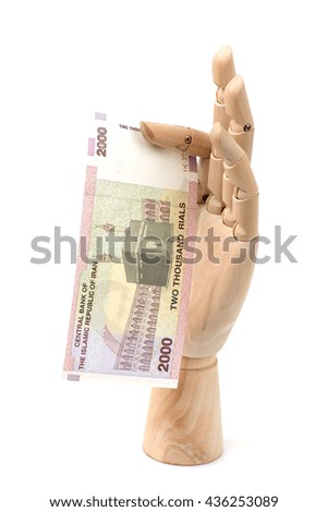 2000 Iranian rials bank note. Rial is the national currency of Iran. money in hand wood on the white background.