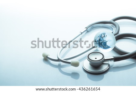 Global healthcare. Globe and stethoscope blue tone on white background