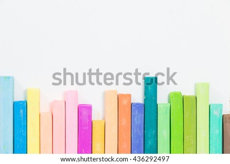Colorful chalk pastels on white background. Concept back to school and color bar graph.